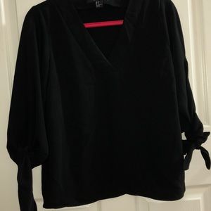 Black blouse with bow sleeves.